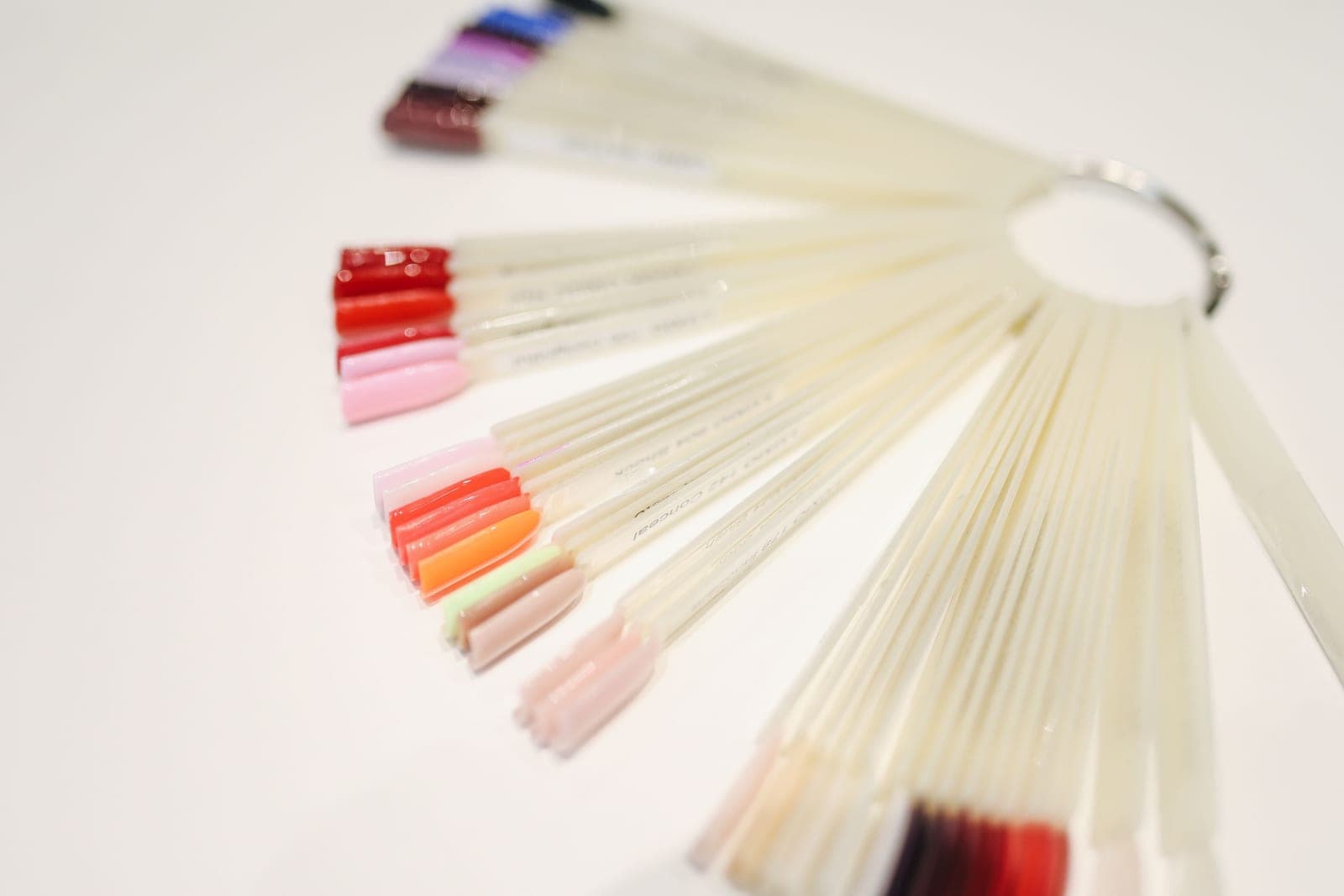 A set of artificial nail tips laid out on a pale surface — a category photo, not this product